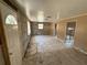 Empty living room with tiled floors and block wall construction awaiting renovation at 6042 Countryman Ln, New Port Richey, FL 34652