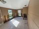 Sunlit living room featuring tile flooring, and three partially framed windows at 6042 Countryman Ln, New Port Richey, FL 34652