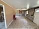 Living room featuring a fireplace, awaiting remodel with exposed block walls and window at 6042 Countryman Ln, New Port Richey, FL 34652