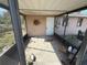 Porch featuring screens, a white back door, and a metal sun ornament at 6042 Countryman Ln, New Port Richey, FL 34652