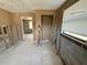 View of room featuring exposed framing and block walls, with window and bare floors at 6042 Countryman Ln, New Port Richey, FL 34652