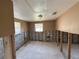 Interior room with exposed framing, block walls, window, and a standard light fixture at 6042 Countryman Ln, New Port Richey, FL 34652