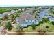 Aerial view of the lovely home and the surrounding community, with mature trees and canal access at 613 Manns Harbor Dr, Apollo Beach, FL 33572