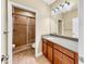 This full bathroom features granite countertops, wood cabinets, and tiled shower at 613 Manns Harbor Dr, Apollo Beach, FL 33572