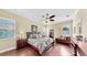 Comfortable bedroom with hardwood floors, a ceiling fan, and natural light from the windows at 613 Manns Harbor Dr, Apollo Beach, FL 33572