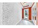 Bright entryway with textured walls, tile flooring, and a glass-paneled front door at 613 Manns Harbor Dr, Apollo Beach, FL 33572