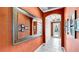 Inviting entryway with tile floors, stylish mirror, and bright lighting at 613 Manns Harbor Dr, Apollo Beach, FL 33572