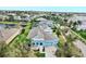Bright blue home boasts a spacious three-car garage, landscaped yard, and a charming front porch at 613 Manns Harbor Dr, Apollo Beach, FL 33572