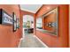 Hallway leading to kitchen and living area, with a decorative mirror and framed pictures at 613 Manns Harbor Dr, Apollo Beach, FL 33572
