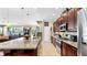 Open concept kitchen with large island, stainless steel appliances, and rich wood cabinetry at 613 Manns Harbor Dr, Apollo Beach, FL 33572