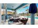 Covered lanai featuring outdoor kitchen, comfortable seating, and a beautiful pool with waterfront views at 613 Manns Harbor Dr, Apollo Beach, FL 33572