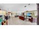 Expansive open-concept living room with tile flooring, a large dining table, and modern decor at 613 Manns Harbor Dr, Apollo Beach, FL 33572