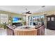 Cozy living room with a large television, comfortable seating, and sliding glass doors to the outdoor patio at 613 Manns Harbor Dr, Apollo Beach, FL 33572