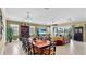 Open concept living area with dining table, leather sofa, and large TV, perfect for entertaining at 613 Manns Harbor Dr, Apollo Beach, FL 33572