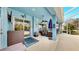 Covered lanai has blue decor, ceiling fan and an outdoor seating area at 613 Manns Harbor Dr, Apollo Beach, FL 33572