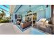 Relaxing covered patio featuring comfortable seating, a built-in grill, and views of the pool at 613 Manns Harbor Dr, Apollo Beach, FL 33572