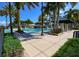 Community pool area has lounge chairs, landscaping and covered cabana area at 613 Manns Harbor Dr, Apollo Beach, FL 33572