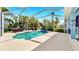 Beautiful screened-in pool area with tropical foliage, providing a private oasis for relaxation and recreation at 613 Manns Harbor Dr, Apollo Beach, FL 33572