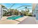 Screened-in pool area surrounded by lush landscaping at 613 Manns Harbor Dr, Apollo Beach, FL 33572