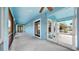 Outdoor porch in blue with ceiling fans and access to main living at 613 Manns Harbor Dr, Apollo Beach, FL 33572