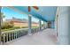 Outdoor porch in blue with ceiling fans and view of the landscaping at 613 Manns Harbor Dr, Apollo Beach, FL 33572