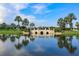 Beautiful view of a bridge over water, surrounded by lush greenery and palm trees at 613 Manns Harbor Dr, Apollo Beach, FL 33572