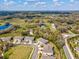 The aerial view of this neighborhood includes homes, ponds, and green vegetation, creating a scenic landscape at 6930 Ripple Pond Loop, Zephyrhills, FL 33541