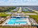 An aerial shot reveals a community pool, clubhouse, playground and rows of attractive single Gathering homes at 6930 Ripple Pond Loop, Zephyrhills, FL 33541