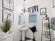 Chic bathroom with modern fixtures, decorative art, vanity, and a pedestal sink offers a stylish and functional design at 6930 Ripple Pond Loop, Zephyrhills, FL 33541