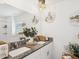 Bright bathroom featuring a double sink with granite countertops, mirrors, and modern lighting at 6930 Ripple Pond Loop, Zephyrhills, FL 33541