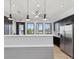 Convenient kitchenette features stainless steel appliances, sleek countertops, and modern cabinetry at 6930 Ripple Pond Loop, Zephyrhills, FL 33541