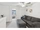 Cozy living area with a comfortable sofa and ottoman, leading into the bedroom at 6930 Ripple Pond Loop, Zephyrhills, FL 33541