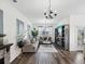 Spacious living room with hardwood floors, modern decor, and plenty of natural light at 6930 Ripple Pond Loop, Zephyrhills, FL 33541