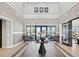 Inviting lobby entrance features attractive flooring, modern seating, and light, neutral colors at 6930 Ripple Pond Loop, Zephyrhills, FL 33541