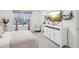 Bright main bedroom features a large window and stylish decor at 6930 Ripple Pond Loop, Zephyrhills, FL 33541