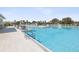 Sparkling pool with multiple access points and lounge areas, a perfect spot for relaxation at 6930 Ripple Pond Loop, Zephyrhills, FL 33541