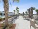 Poolside retreat with seating areas, umbrellas, and lush landscaping, creating a serene atmosphere at 6930 Ripple Pond Loop, Zephyrhills, FL 33541