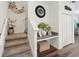Landing featuring wood-look flooring, carpeted stairs, decorative accents, and convenient wall mounted table with stone top at 6930 Ripple Pond Loop, Zephyrhills, FL 33541
