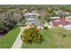 Aerial view of the property showcasing the home's layout, screened pool, mature trees, and spacious yard at 8518 Delaware Dr, Weeki Wachee, FL 34607