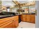 An elegant bathroom features dark countertops and a large framed mirror over wood cabinets at 8518 Delaware Dr, Weeki Wachee, FL 34607