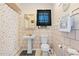 Bright bathroom with pedestal sink, toilet, and a shower/tub combo with a tiled wall and a black and white shower curtain at 8518 Delaware Dr, Weeki Wachee, FL 34607