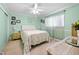 A cozy bedroom offers a ceiling fan and a plush floral patterned bedspread at 8518 Delaware Dr, Weeki Wachee, FL 34607