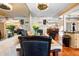 Bright dining area with leather chairs, a mirrored wall, and adjacent kitchen at 8518 Delaware Dr, Weeki Wachee, FL 34607