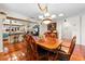 Charming dining room featuring a wooden table, chandelier, and views into the kitchen at 8518 Delaware Dr, Weeki Wachee, FL 34607