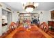 Elegant dining room with a large wooden table, chandelier, and access to other living spaces at 8518 Delaware Dr, Weeki Wachee, FL 34607