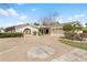 Inviting home exterior with a circular driveway, fountain, and lush landscaping, offering great curb appeal at 8518 Delaware Dr, Weeki Wachee, FL 34607