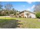 Well-maintained front yard with lush landscaping, showcasing the home's unique architecture with stone accents at 8518 Delaware Dr, Weeki Wachee, FL 34607