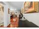 Long hallway leads to an open kitchen and dining area with tile flooring at 8518 Delaware Dr, Weeki Wachee, FL 34607