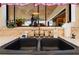 Close-up of a modern kitchen sink with fixtures and a view out a window at 8518 Delaware Dr, Weeki Wachee, FL 34607