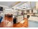 Open kitchen with a granite island, wine cooler, and view into the dining room at 8518 Delaware Dr, Weeki Wachee, FL 34607